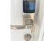 Close up view of the modern smart lock on the white front door at 7015 Cobblewood Ct, Tampa, FL 33615