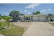 Charming home featuring a two-car garage, brick accents, and a well-maintained front yard under a bright sky at 7015 Cobblewood Ct, Tampa, FL 33615
