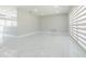 Spacious living room with tile floors, open to the kitchen, and featuring a bright window with modern blinds at 7015 Cobblewood Ct, Tampa, FL 33615