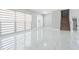 Bright, spacious living room with tile flooring, featuring large window, staircase, and neutral paint at 7015 Cobblewood Ct, Tampa, FL 33615