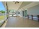 Spacious screened patio with neutral tile floors, offering a comfortable outdoor living space at 7015 Cobblewood Ct, Tampa, FL 33615