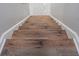 Close-up of wood-look flooring on stairs with white trim at 7015 Cobblewood Ct, Tampa, FL 33615