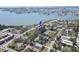 An aerial view displays a building adjacent to a tennis court and a body of water at 7037 Sunset S Dr # 205, South Pasadena, FL 33707