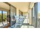 Inviting outdoor balcony area featuring a small table and chairs for relaxing and enjoying the view at 7037 Sunset S Dr # 205, South Pasadena, FL 33707