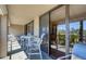 Relaxing balcony space with a table and chairs offering a pleasant outdoor experience at 7037 Sunset S Dr # 205, South Pasadena, FL 33707