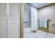 Bathroom featuring built-in shelves and a bathtub with white subway tile surround and glass shower door at 7037 Sunset S Dr # 205, South Pasadena, FL 33707