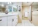 Clean bathroom featuring white cabinets, modern fixtures, and a tiled shower at 7037 Sunset S Dr # 205, South Pasadena, FL 33707