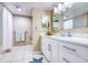 Bathroom showcasing a modern vanity, a large mirror, and a shower behind a curtain at 7037 Sunset S Dr # 205, South Pasadena, FL 33707