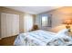 Bedroom featuring plantation shutters, a closet, and a tropical themed bed set at 7037 Sunset S Dr # 205, South Pasadena, FL 33707