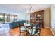 Open-concept living space with wood floors, glass table, decorative chairs, and sliding glass doors at 7037 Sunset S Dr # 205, South Pasadena, FL 33707