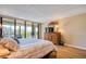 Bright main bedroom with a sliding glass door to balcony and a wooden dresser with a TV at 7037 Sunset S Dr # 205, South Pasadena, FL 33707
