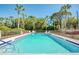 Community pool with lounge chairs, a lifeguard ring, and tropical foliage at 7037 Sunset S Dr # 205, South Pasadena, FL 33707