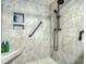 Bathroom shower featuring built-in shelving, a bench, and a modern shower head at 7037 Sunset S Dr # 205, South Pasadena, FL 33707