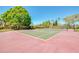 A beautifully maintained tennis court sits ready for a match on a clear and sunny day at 7037 Sunset S Dr # 205, South Pasadena, FL 33707