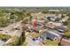 Residential home in a neighborhood featuring a screened-in pool, solar panels, and proximity to a main street at 7428 Bramblewood Dr, Port Richey, FL 34668