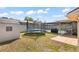 Large backyard with a shed and a trampoline at 7428 Bramblewood Dr, Port Richey, FL 34668