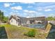 Backyard with a screened-in pool and solar panels on the roof at 7428 Bramblewood Dr, Port Richey, FL 34668