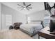 Spacious bedroom featuring a ceiling fan, two windows, and a comfortable bed at 7428 Bramblewood Dr, Port Richey, FL 34668