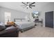 Well-lit bedroom with a queen-sized bed, ceiling fan, and a wall-mounted television at 7428 Bramblewood Dr, Port Richey, FL 34668