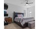 Cozy bedroom featuring a queen bed with gray and white striped bedding and dark wood furniture at 7428 Bramblewood Dr, Port Richey, FL 34668