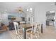 Bright dining room with wood table and chairs and a view into the living room at 7428 Bramblewood Dr, Port Richey, FL 34668