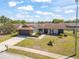 Attractive single-story home with stone accents, solar panels, lush landscaping, and a spacious driveway at 7428 Bramblewood Dr, Port Richey, FL 34668