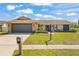 Charming single-story home with a stone-accented facade, well-manicured lawn, and inviting curb appeal at 7428 Bramblewood Dr, Port Richey, FL 34668