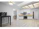 Bright kitchen has wood floors, white cabinets and backsplash, stainless appliances, and butcher block countertops at 7428 Bramblewood Dr, Port Richey, FL 34668