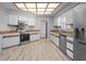 The bright kitchen has wood floors, stainless appliances, white cabinets, and butcher block countertops at 7428 Bramblewood Dr, Port Richey, FL 34668