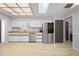 Open-concept kitchen with stainless steel appliances and light wood countertops at 7428 Bramblewood Dr, Port Richey, FL 34668