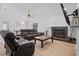 Cozy living room with a fireplace, comfortable seating, and a ceiling fan for added comfort at 7428 Bramblewood Dr, Port Richey, FL 34668