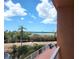 Lovely balcony view featuring tranquil water and lush palm trees at 7430 Sunshine Skyway S Ln # 305, St Petersburg, FL 33711