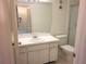 Bright bathroom with white cabinets, updated vanity, and glass shower enclosure at 7430 Sunshine Skyway S Ln # 305, St Petersburg, FL 33711