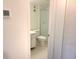 Bathroom featuring a white toilet, sliding glass door, and white cabinets at 7430 Sunshine Skyway S Ln # 305, St Petersburg, FL 33711