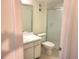 Bathroom featuring a white toilet, shower with sliding glass door, and white cabinets at 7430 Sunshine Skyway S Ln # 305, St Petersburg, FL 33711