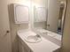 Neutral-toned bathroom featuring white cabinets, ample counter space, and a large mirror at 7430 Sunshine Skyway S Ln # 305, St Petersburg, FL 33711