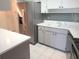 White kitchen featuring stainless steel appliances, white cabinets and modern countertops at 7430 Sunshine Skyway S Ln # 305, St Petersburg, FL 33711