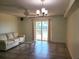 Living room with neutral decor and tile flooring with sliding doors to a private balcony at 7430 Sunshine Skyway S Ln # 305, St Petersburg, FL 33711