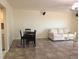 Open living room and dining area with tile flooring, neutral paint, and modern lighting at 7430 Sunshine Skyway S Ln # 305, St Petersburg, FL 33711