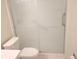 This updated bathroom features a shower with sliding glass doors and white tile at 7430 Sunshine Skyway S Ln # 305, St Petersburg, FL 33711