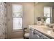 Bathroom featuring a vanity, a toilet, and a window with blinds at 7850 Lake Placid Ln, New Port Richey, FL 34655