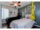Well-decorated bedroom with two beds, ceiling fan, and charming wall decor at 7850 Lake Placid Ln, New Port Richey, FL 34655