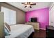 Cozy bedroom highlighted by a bright accent wall and comfortable furniture at 7850 Lake Placid Ln, New Port Richey, FL 34655