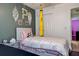 Charming bedroom featuring a whimsical design and unique decor accents on the olive green wall at 7850 Lake Placid Ln, New Port Richey, FL 34655