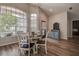 Bright dining area featuring a round table, stylish chairs, and arched windows with natural light at 7850 Lake Placid Ln, New Port Richey, FL 34655