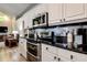 Modern kitchen features granite countertops, stainless steel appliances, and white cabinets at 7850 Lake Placid Ln, New Port Richey, FL 34655