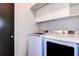 Practical laundry room equipped with modern washer and dryer units for convenience at 7850 Lake Placid Ln, New Port Richey, FL 34655