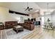 Spacious living room features a ceiling fan, wood floors, and comfortable leather seating at 7850 Lake Placid Ln, New Port Richey, FL 34655