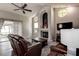 Relaxing living room offers a fireplace, wood floors, and natural light from surrounding windows at 7850 Lake Placid Ln, New Port Richey, FL 34655