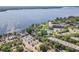 Panoramic view of community featuring pool, tennis courts, parking, and lake at 90 S Highland Ave # 6, Tarpon Springs, FL 34689